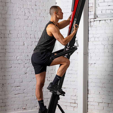 A man doing a workout using the VersaClimber. He is exercising both legs and arms