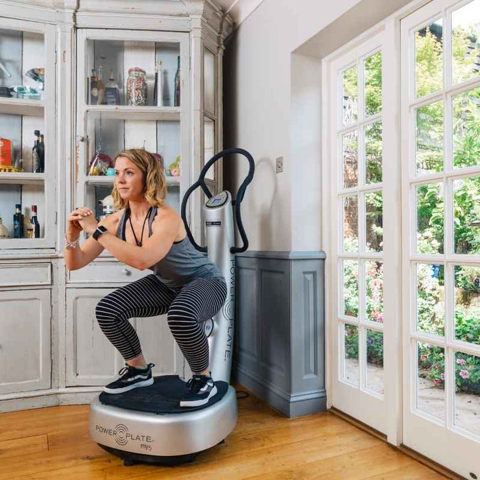 a woman working out on a power plate