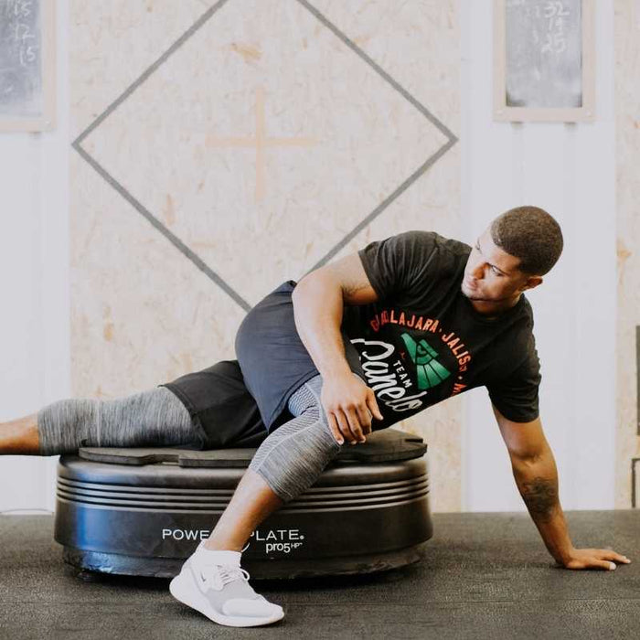 a man stretching on a power plate