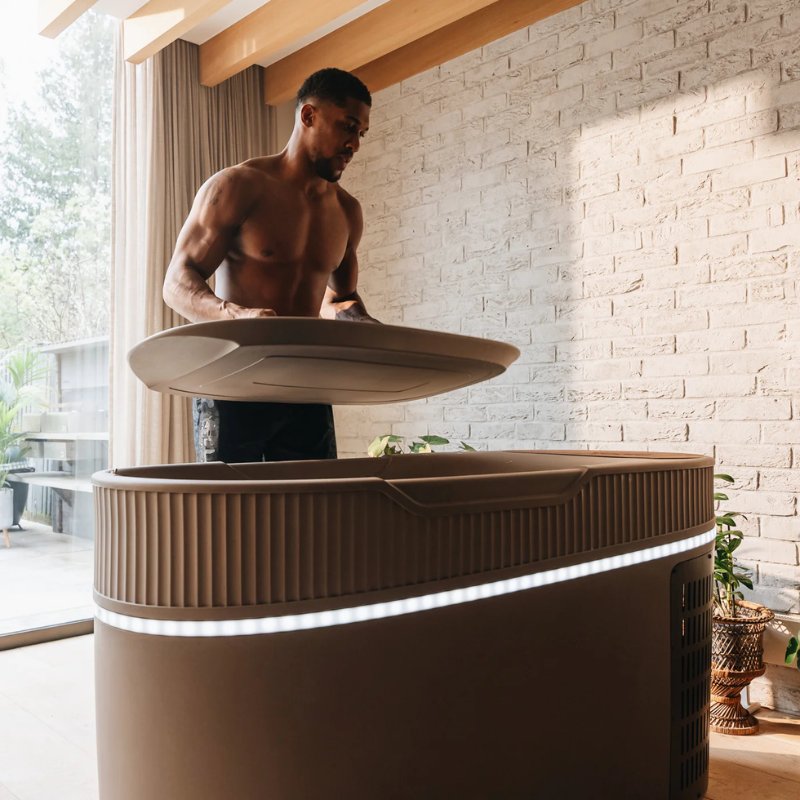 a Man removing Monk Smart Ice Bath Outdoor Cover